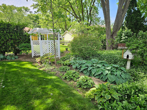 Front yard planting bed with ornamental grasses and a stone retaining wall